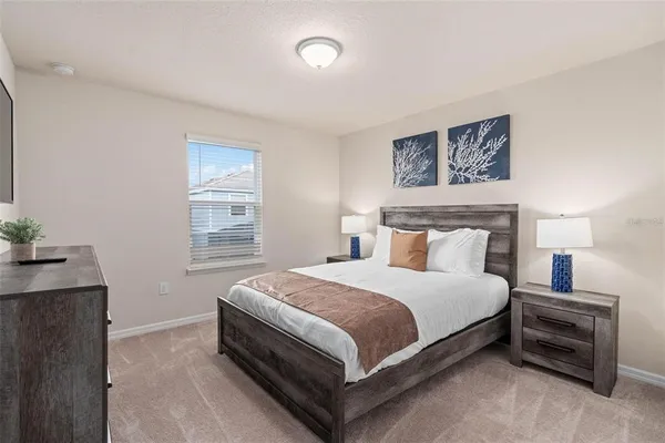 a bedroom with two beds and a window