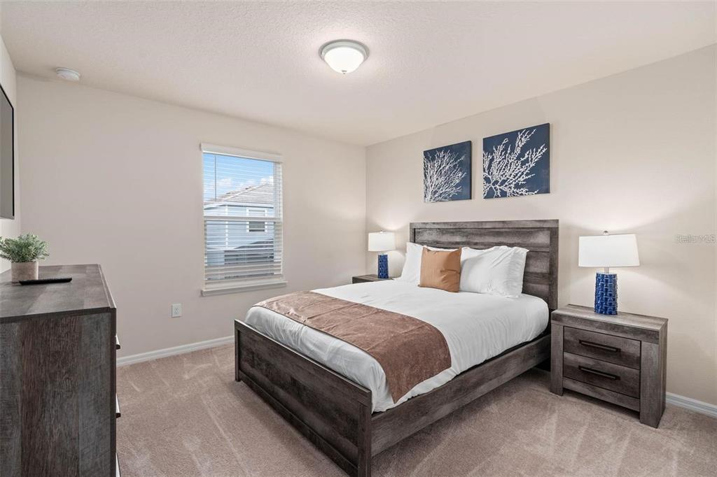 7180 Oakmoss Loop Davenport, FL 33837 - Photo 23 of 29 a bedroom with a bed and a desk