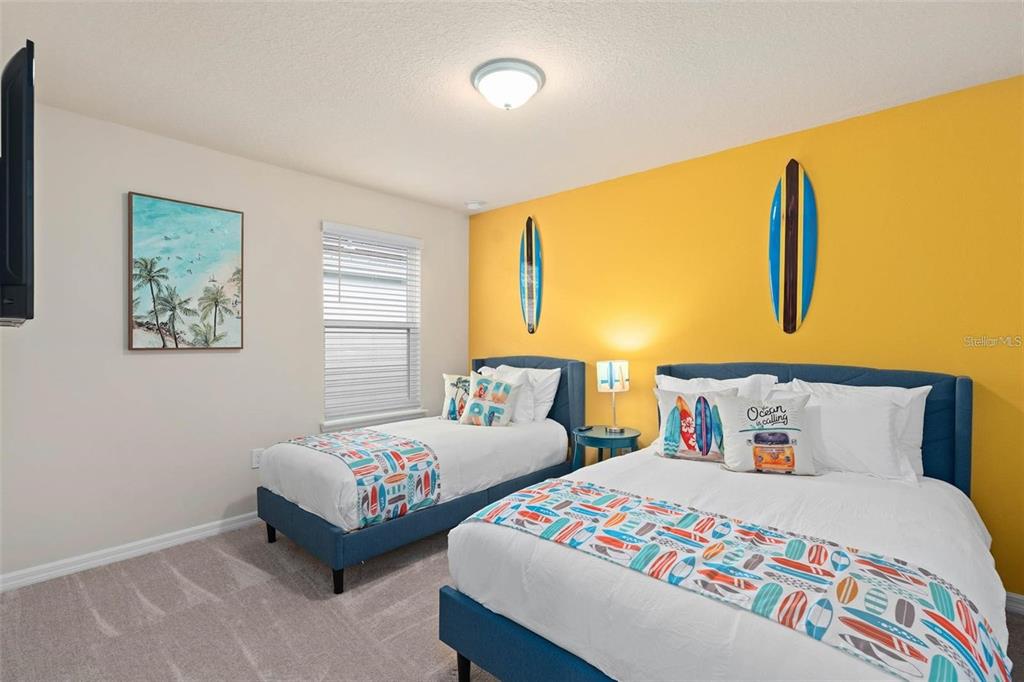 7180 Oakmoss Loop Davenport, FL 33837 - Photo 24 of 29 a bedroom with two beds and a window