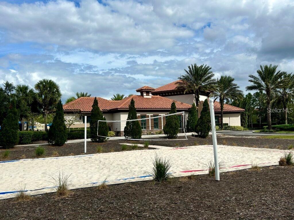 7180 Oakmoss Loop Davenport, FL 33837 - Photo 28 of 29 a view of a white house with a fountain in front of a house
