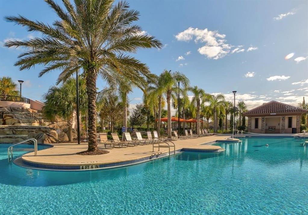 7180 Oakmoss Loop Davenport, FL 33837 - Photo 29 of 29 a view of a swimming pool with a table and chairs
