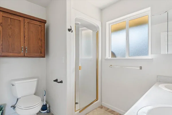 a view of an empty room with window and closet area