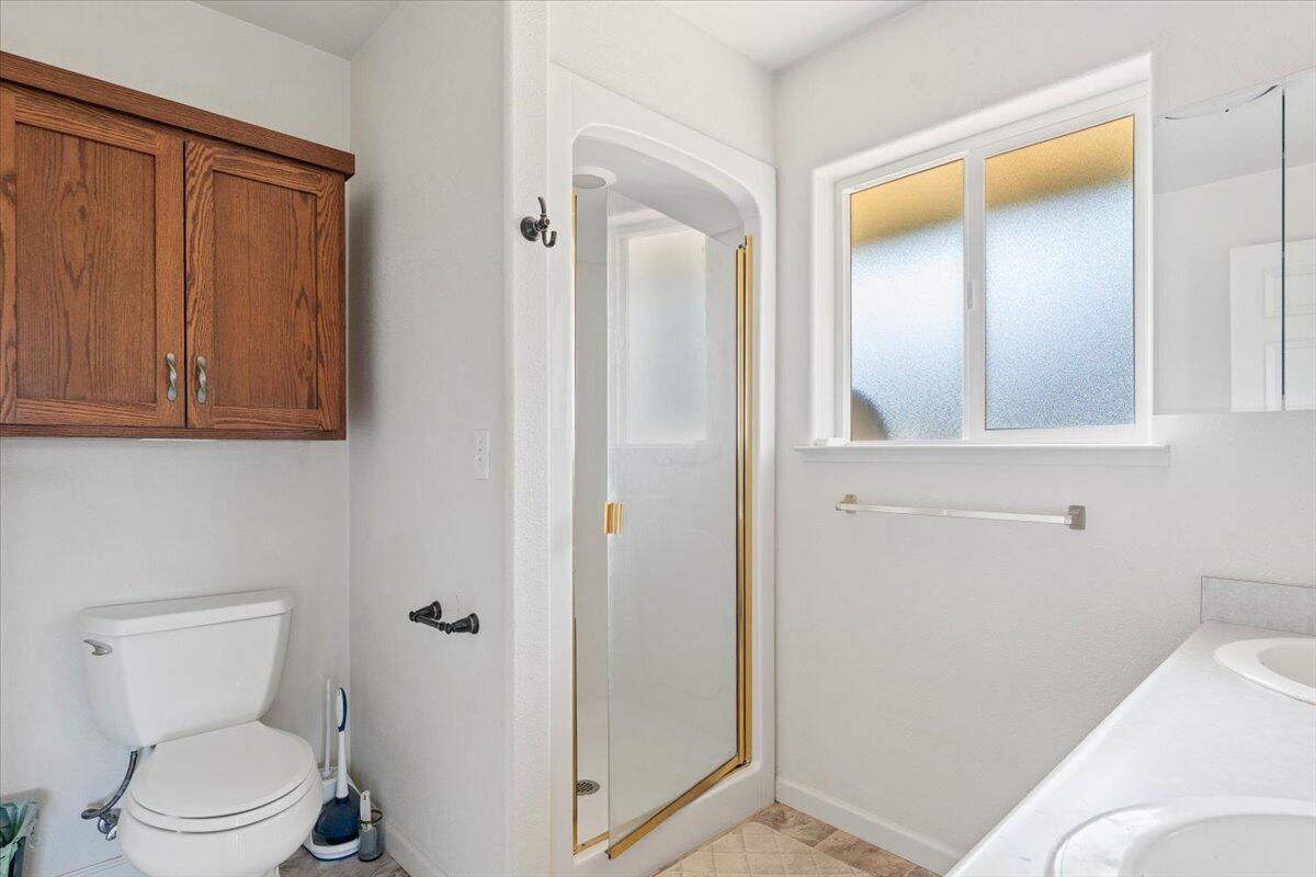 8550 Muletown Road Redding, CA 96001 - Photo 13 of 37 a bathroom with a toilet and a mirror