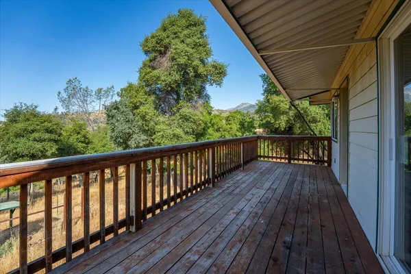 a view of a balcony with wooden floor