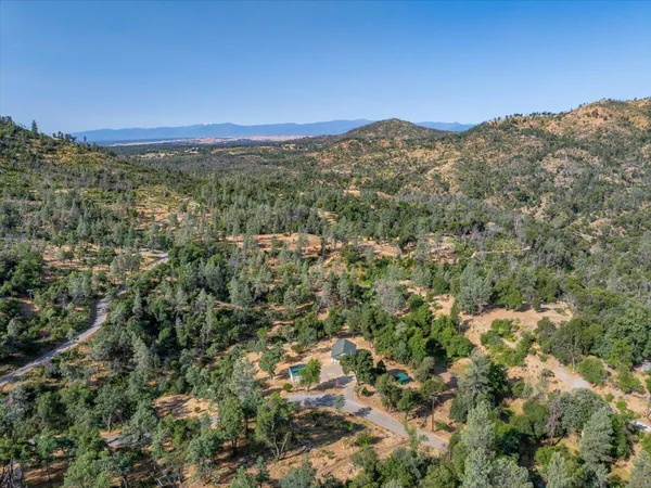 a view of a mountain in the distance in a field