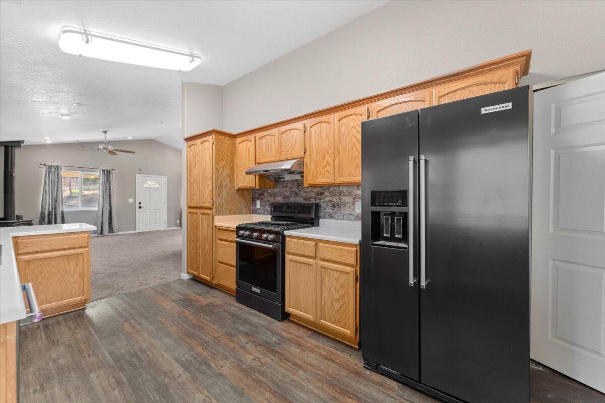 8550 Muletown Road Redding, CA 96001 - Photo 4 of 37 a kitchen with stainless steel appliances granite countertop a refrigerator and a stove top oven