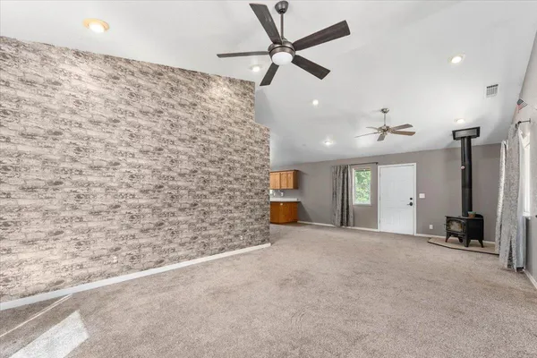a view of a livingroom with a ceiling fan and window