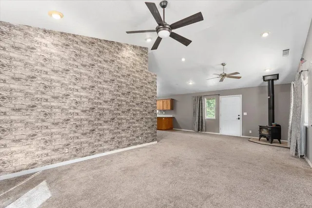 a view of a livingroom with a ceiling fan and window