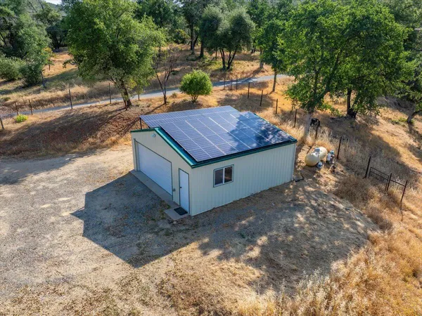 a view of house with backyard space and sitting area