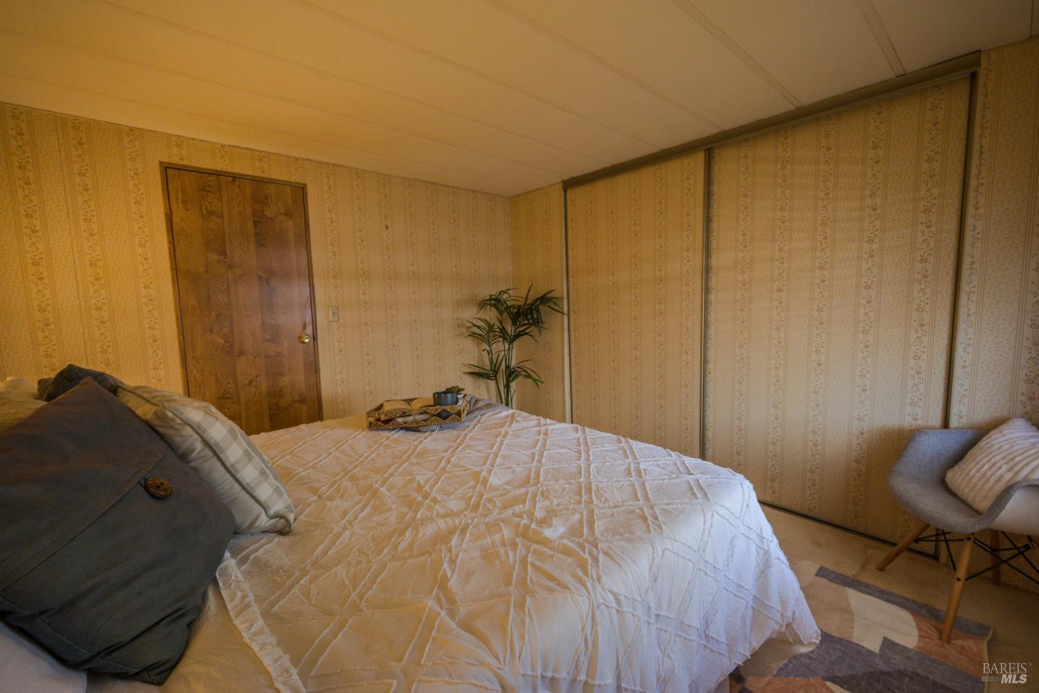 14 Balboa Court Fairfield, CA 94533 - Photo 12 of 27 a bedroom with a bed and a chair