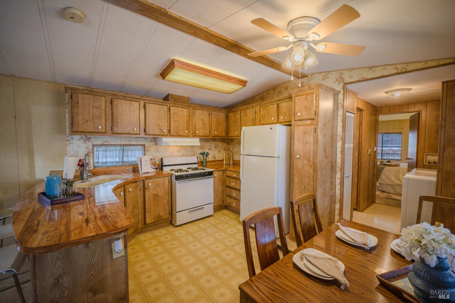 14 Balboa Court Fairfield, CA 94533 - Photo 4 of 27 a kitchen with sink refrigerator and stove