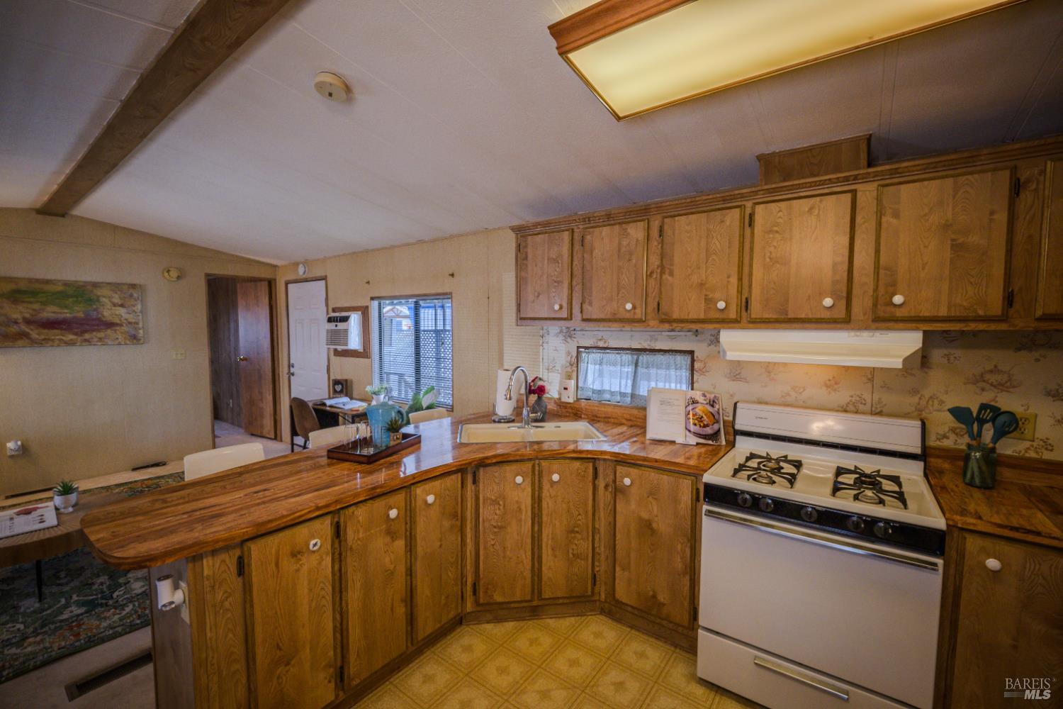 14 Balboa Court Fairfield, CA 94533 - Photo 6 of 27 a kitchen with a sink stove and cabinets