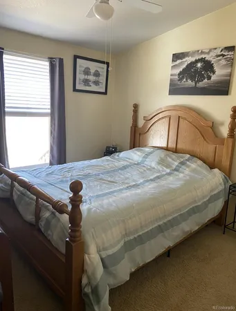 a bedroom with a bed and window