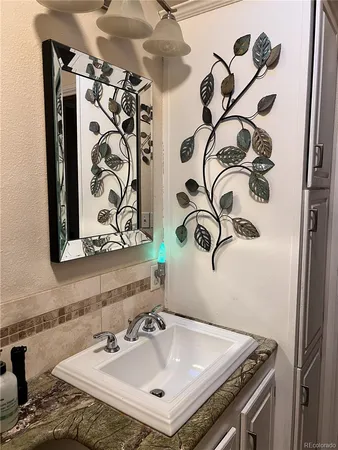 a bathroom with a sink and mirror