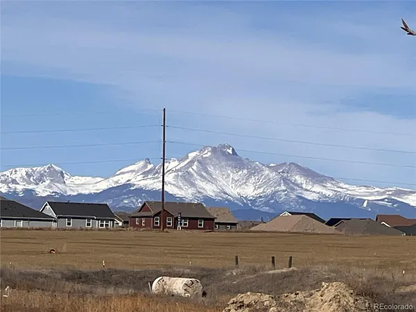 a view of a house with a big yard and large trees