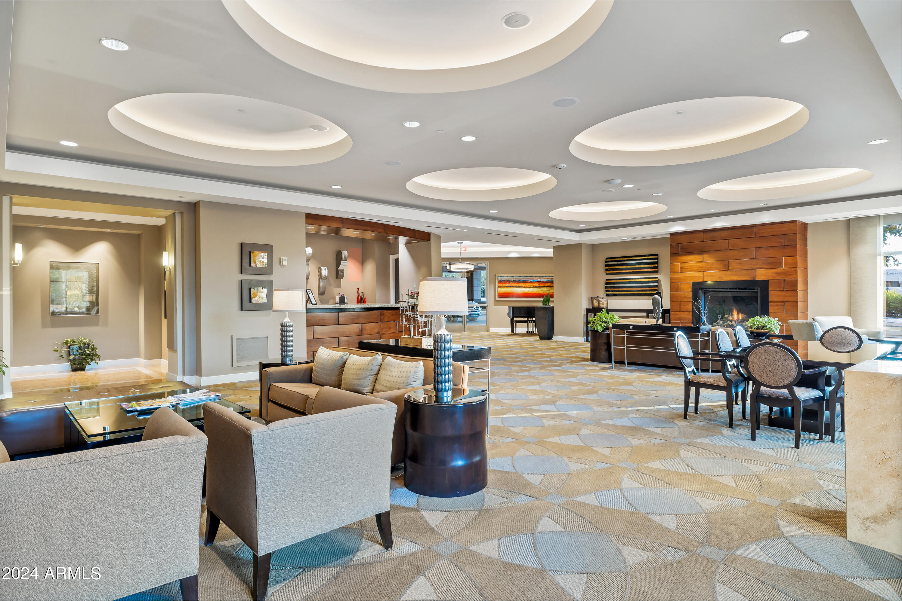2211 East Camelback Road, Unit 407 Phoenix, AZ 85016 - Photo 13 of 36 a living room with furniture and a table