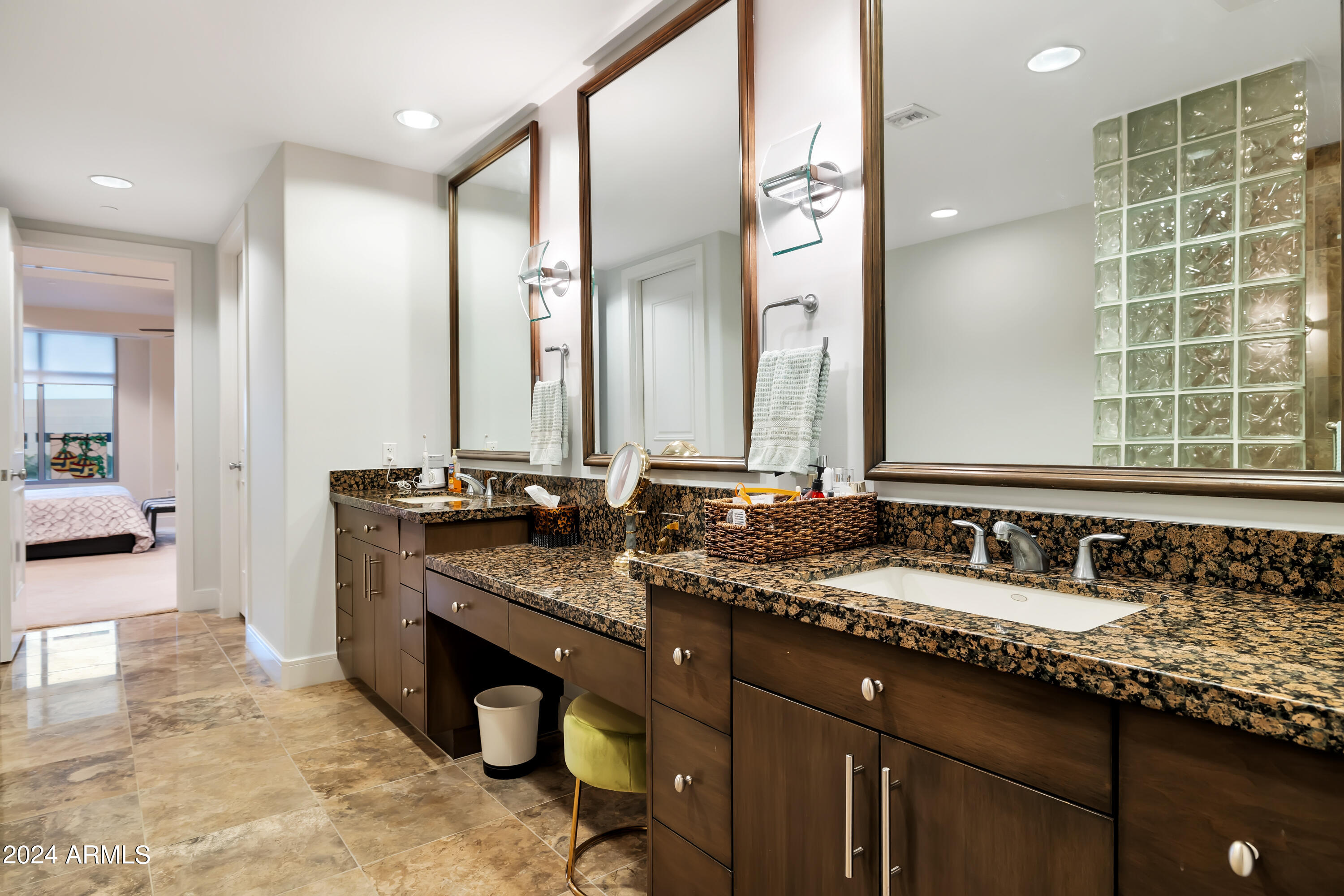2211 East Camelback Road, Unit 407 Phoenix, AZ 85016 - Photo 16 of 36 a bathroom with double vanity sinks and a mirror