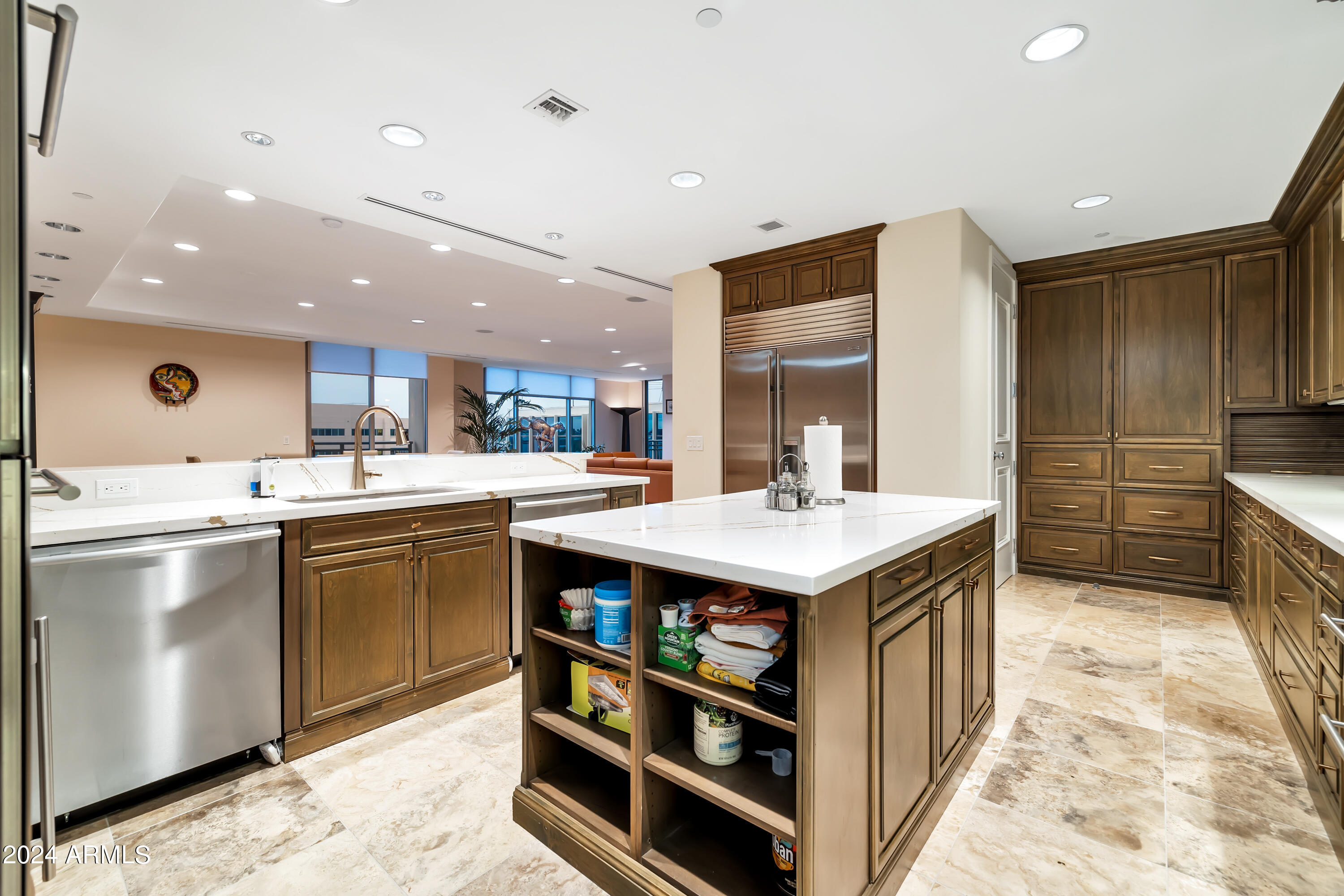 2211 East Camelback Road, Unit 407 Phoenix, AZ 85016 - Photo 17 of 36 a kitchen with kitchen island a sink a stove and a refrigerator