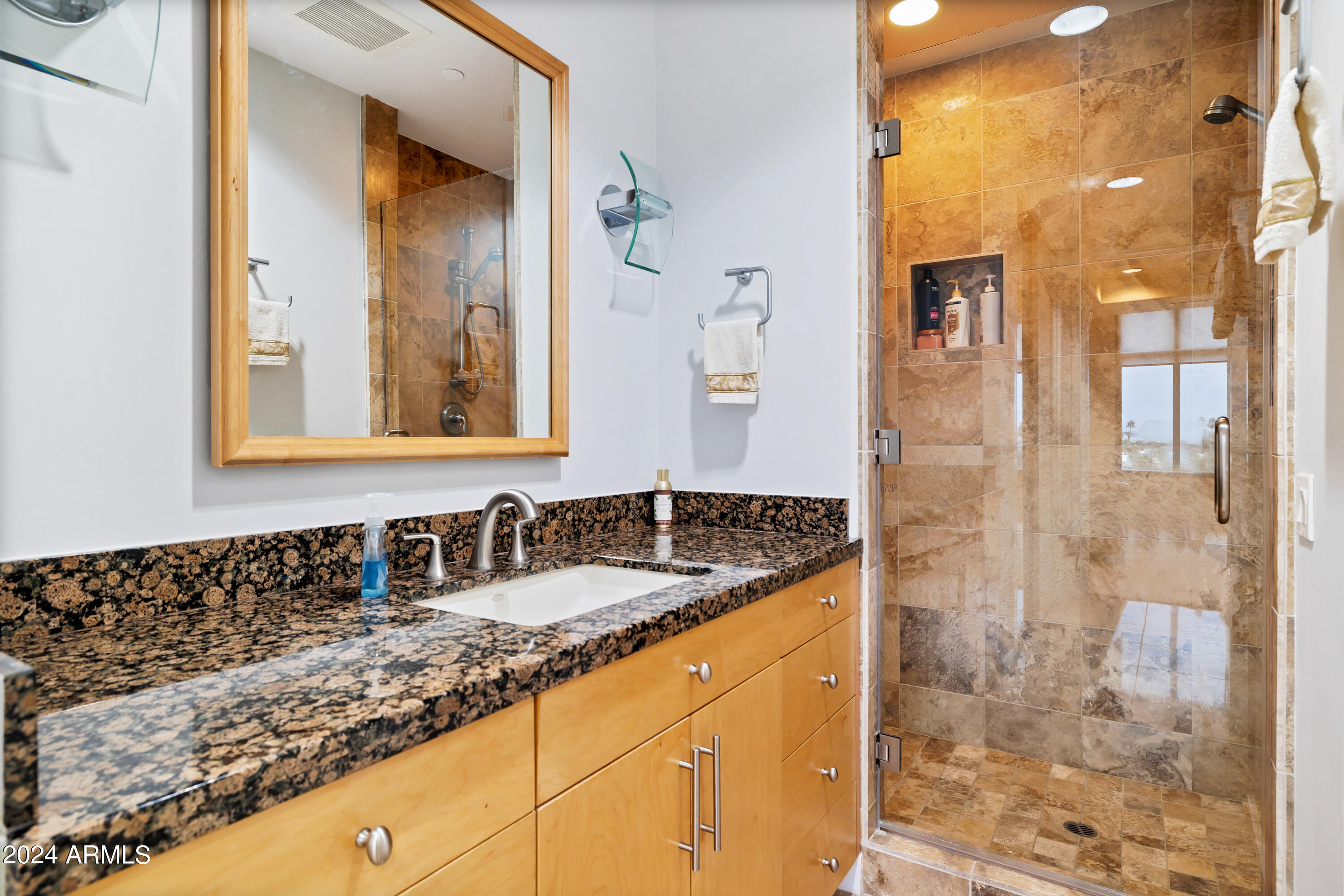 2211 East Camelback Road, Unit 407 Phoenix, AZ 85016 - Photo 24 of 36 a bathroom with a granite countertop sink a mirror and a shower