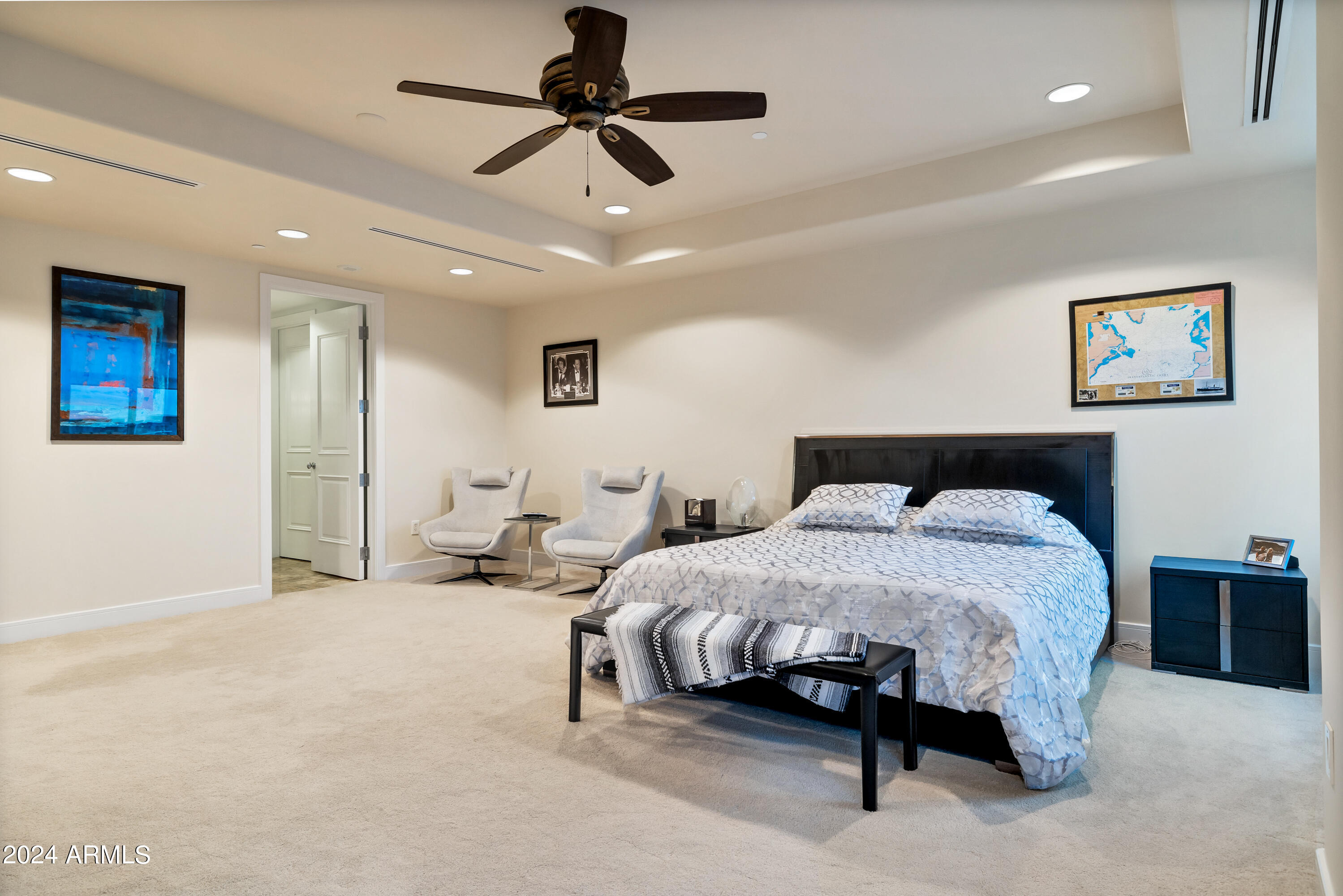 2211 East Camelback Road, Unit 407 Phoenix, AZ 85016 - Photo 27 of 36 a spacious bedroom with a bed and ceiling fan