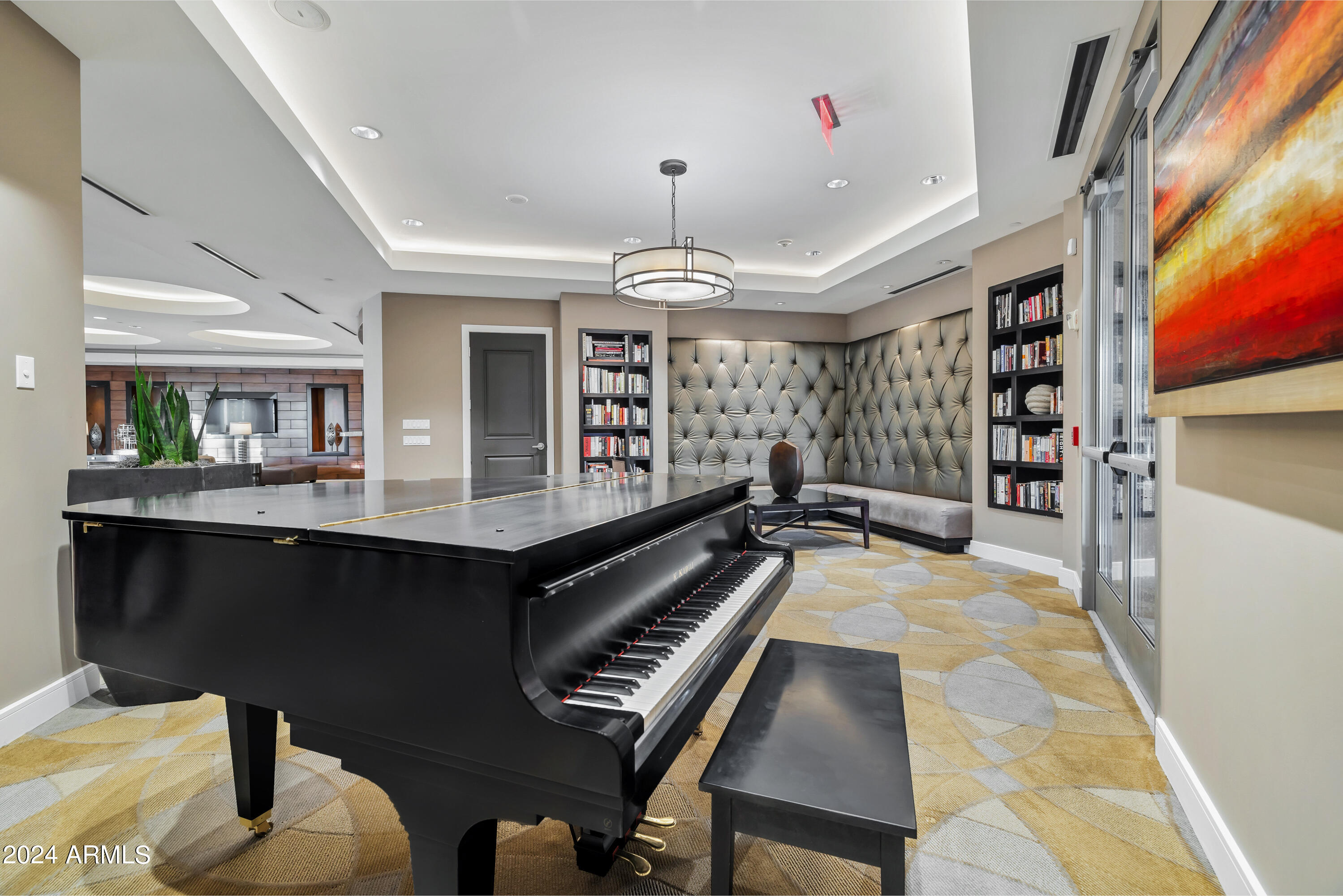 2211 East Camelback Road, Unit 407 Phoenix, AZ 85016 - Photo 29 of 36 a living room with furniture a chandelier and a piano