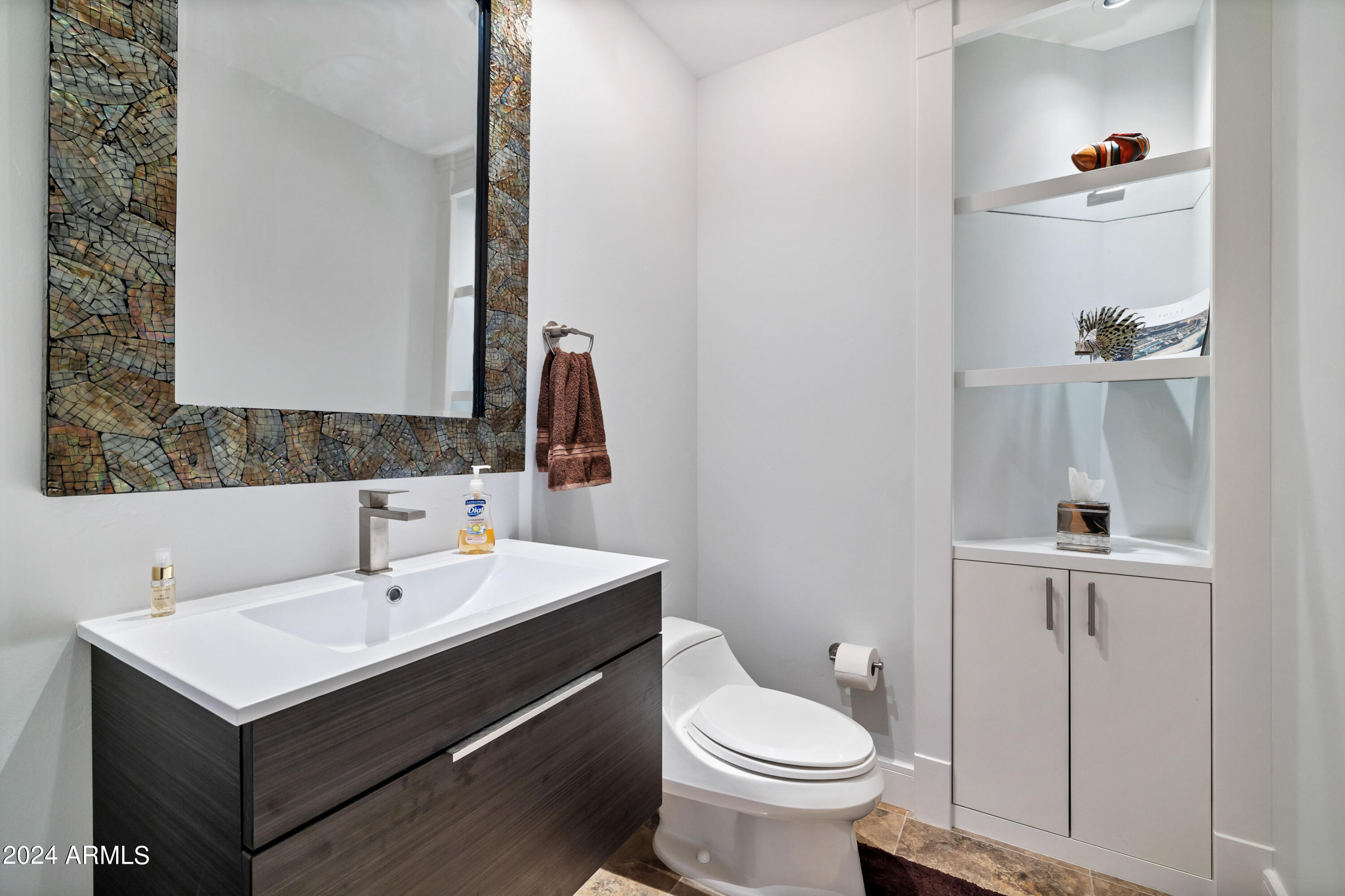 2211 East Camelback Road, Unit 407 Phoenix, AZ 85016 - Photo 30 of 36 a bathroom with a sink toilet and mirror