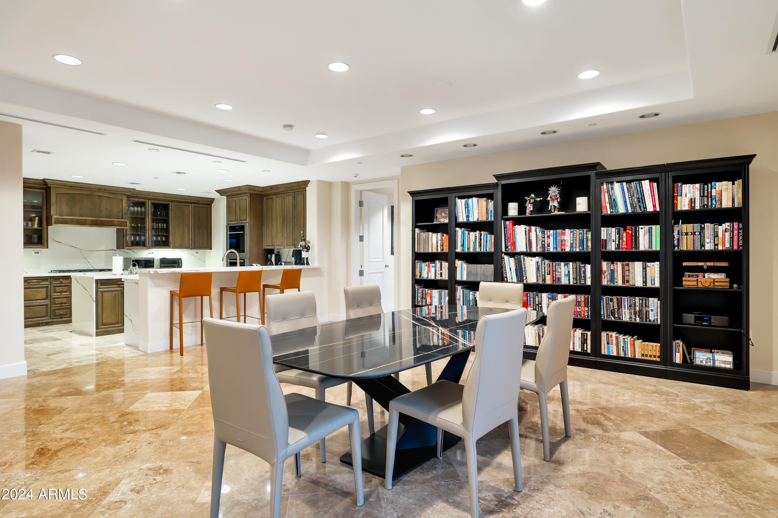 2211 East Camelback Road, Unit 407 Phoenix, AZ 85016 - Photo 5 of 36 a dining room with furniture a rug and a book shelf