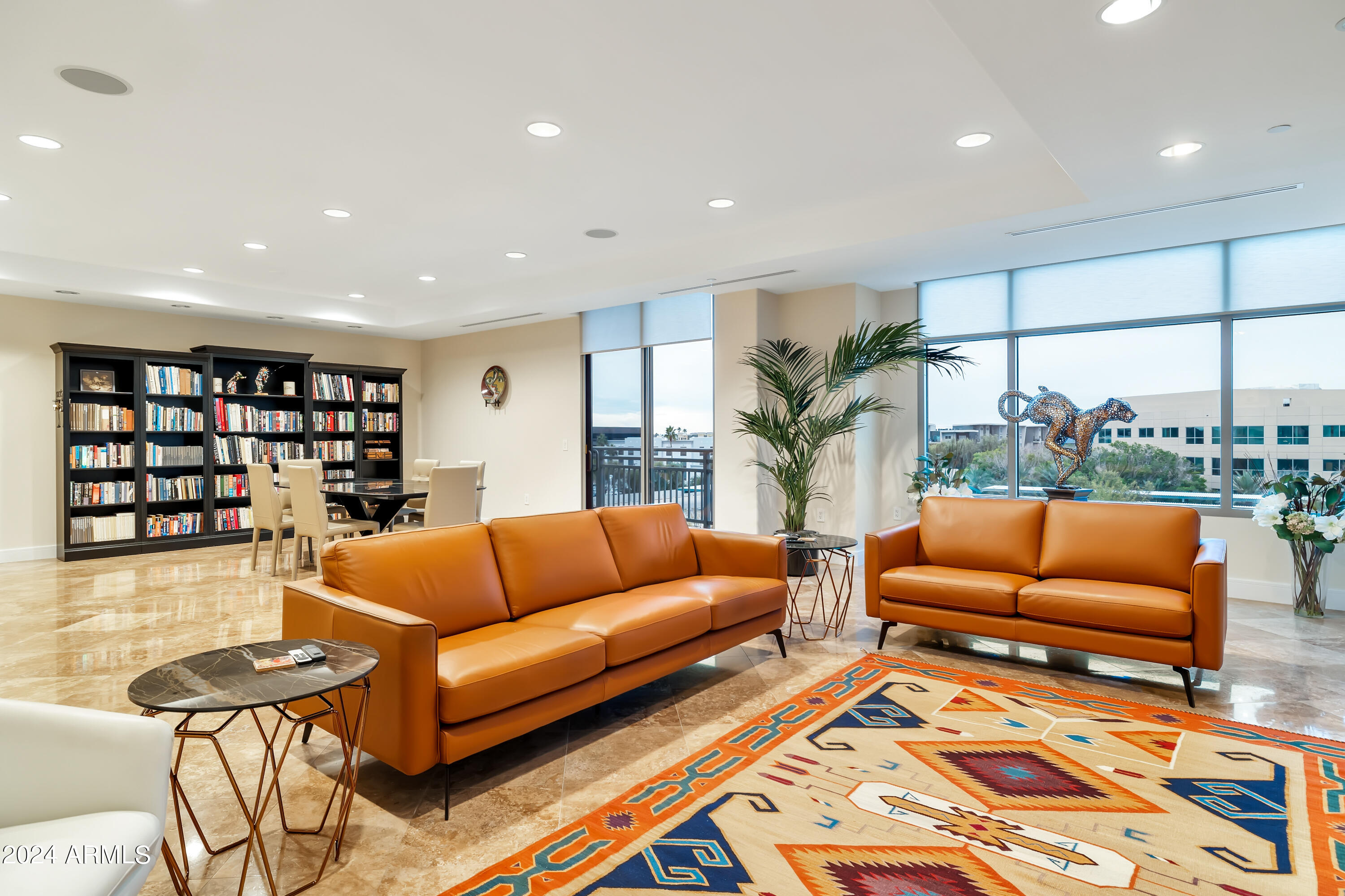 2211 East Camelback Road, Unit 407 Phoenix, AZ 85016 - Photo 6 of 36 a living room with furniture a rug and a large window