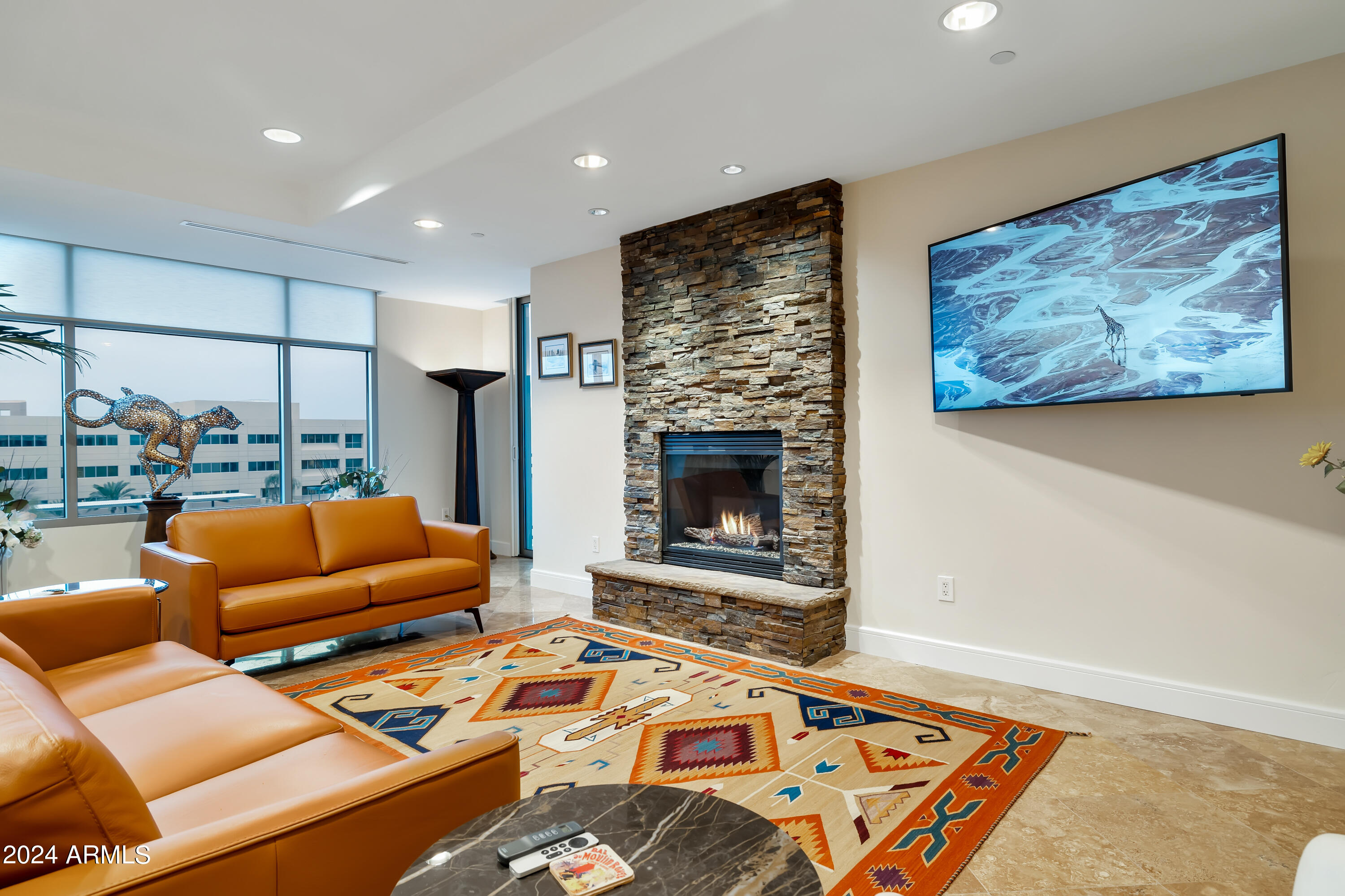 2211 East Camelback Road, Unit 407 Phoenix, AZ 85016 - Photo 7 of 36 a living room with furniture and a fireplace