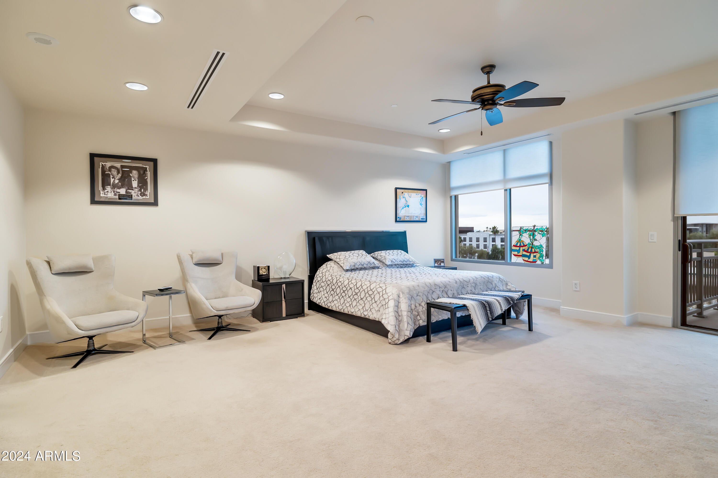 2211 East Camelback Road, Unit 407 Phoenix, AZ 85016 - Photo 8 of 36 a spacious bedroom with a bed and a chandelier