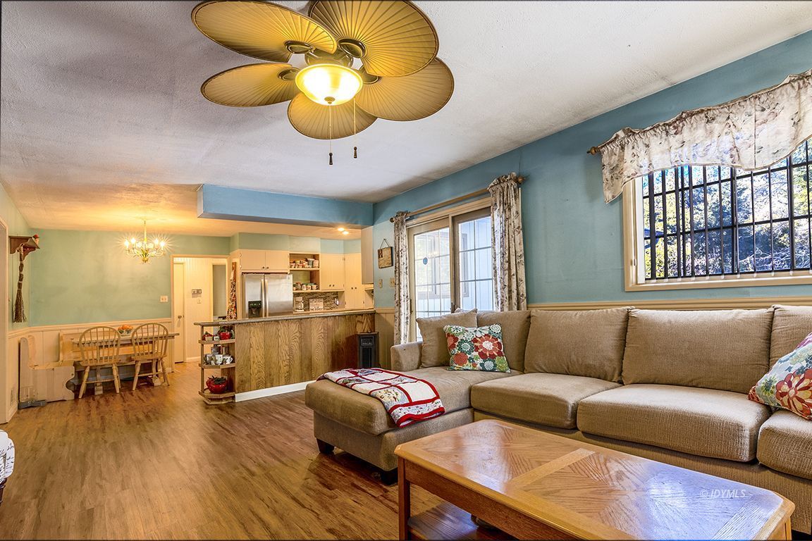 53098 Tollgate Road Idyllwild, CA 92549 - Photo 30 of 54 a living room with furniture wooden floor and a large window