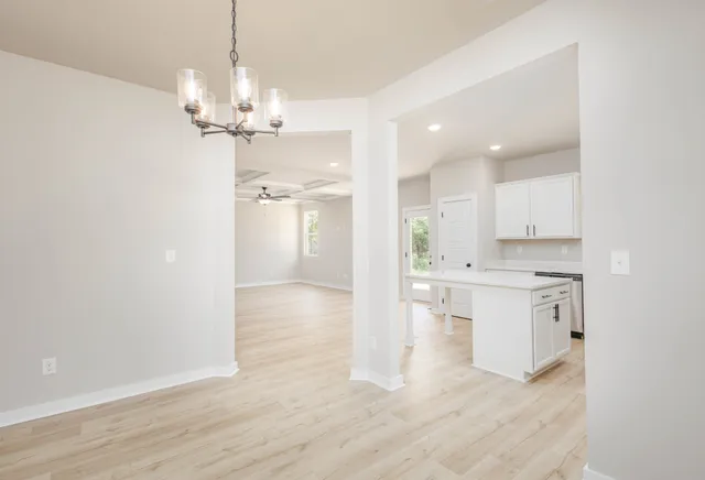 a view of a kitchen counter space a sink wooden floor and kitchen view