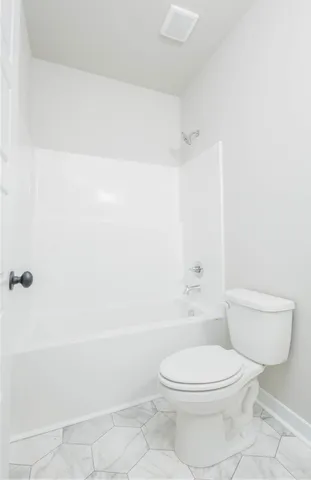 a bathroom with a toilet a sink and shower