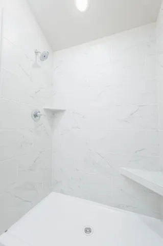 a spacious bathroom with a granite countertop sink and a mirror