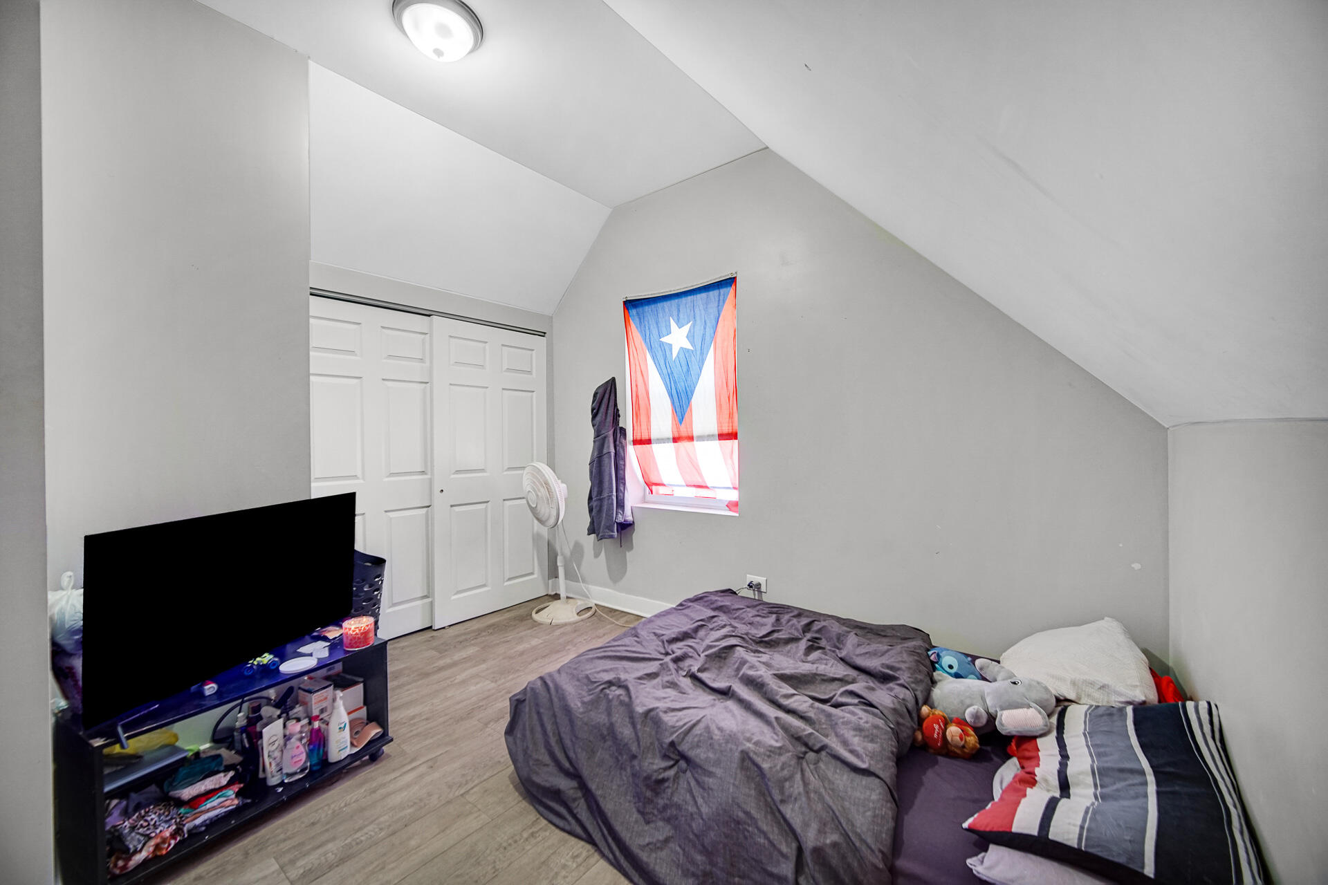 3308 East 12th Avenue Gary, IN 46403 - Photo 8 of 14 a bedroom with bed and a flat screen tv