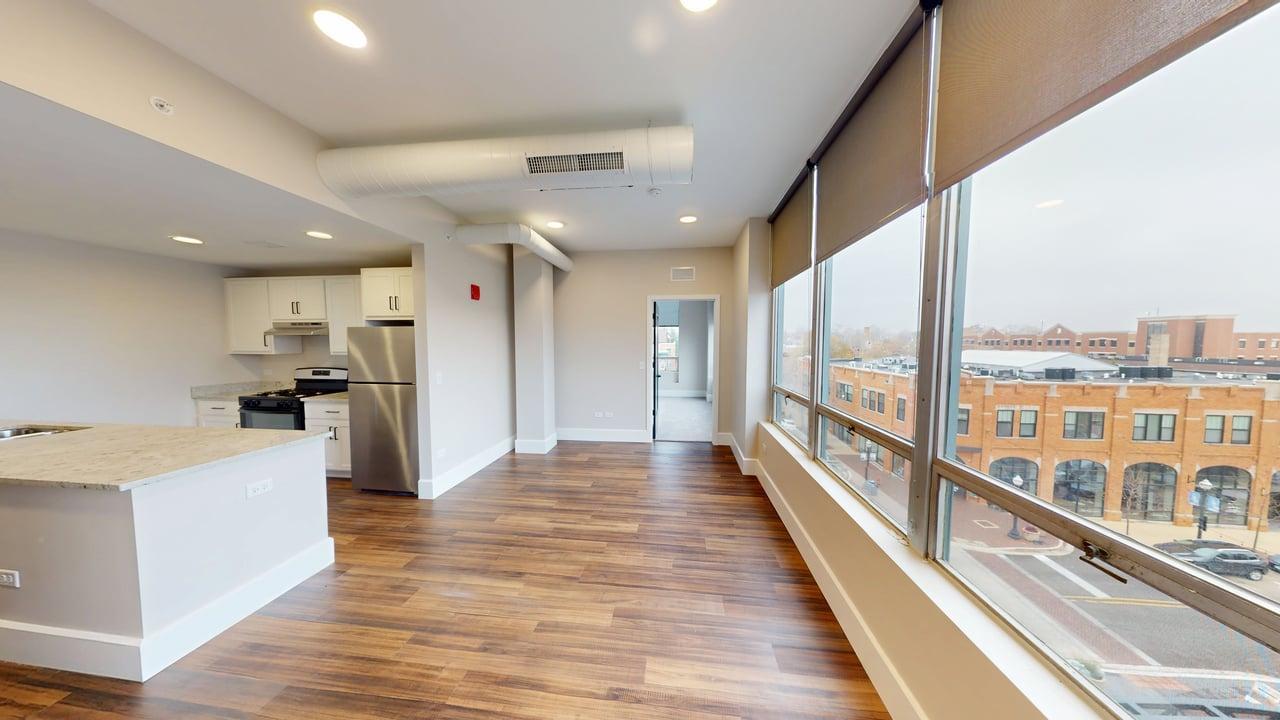 40 Dupage Court, Unit 409 Elgin, IL 60120 - Photo 11 of 22 a view of a kitchen with kitchen island a large counter space a sink and appliances