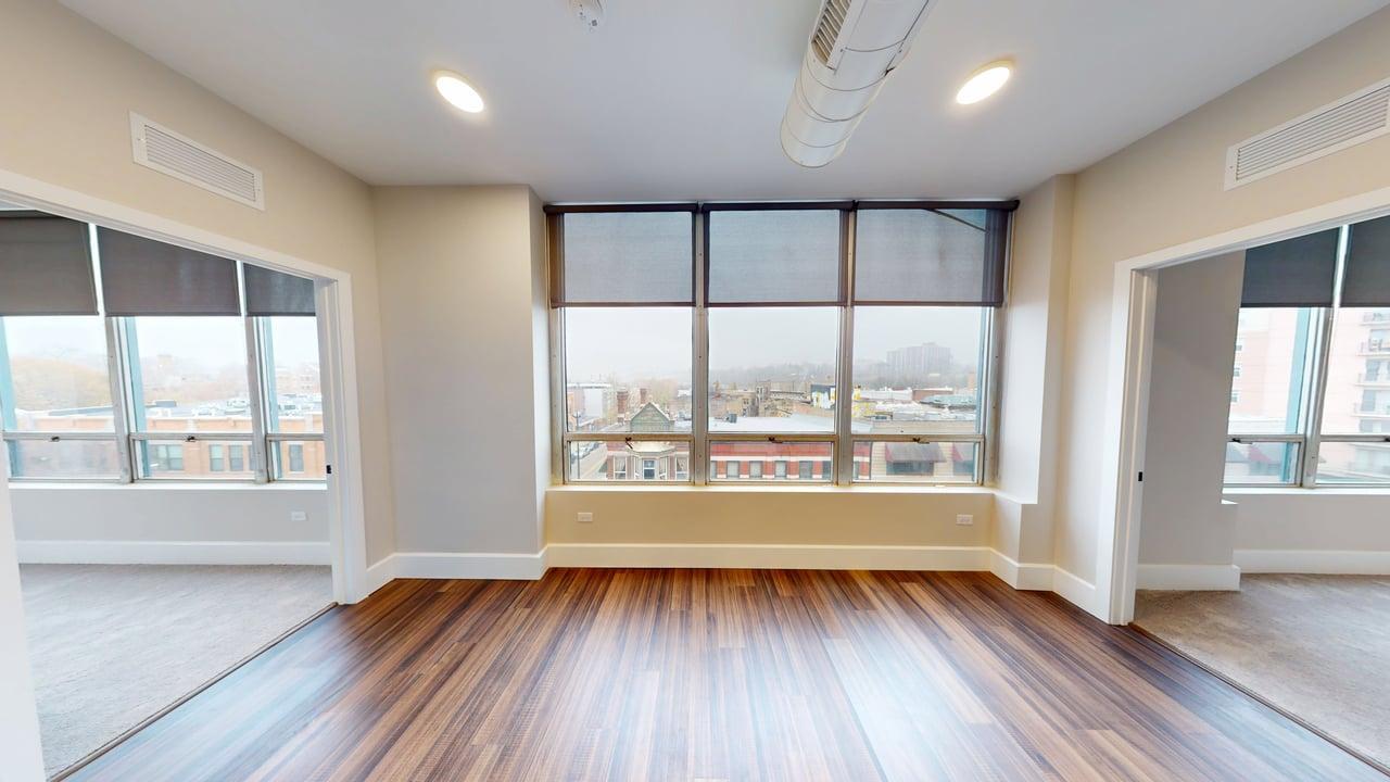 40 Dupage Court, Unit 409 Elgin, IL 60120 - Photo 13 of 22 an empty room with wooden floor and windows