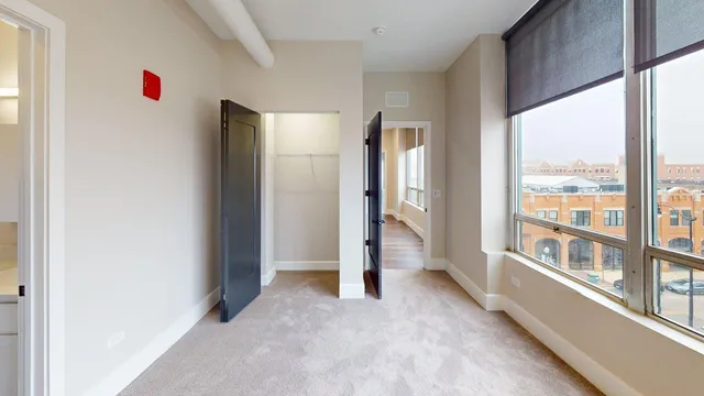 an empty room with large windows