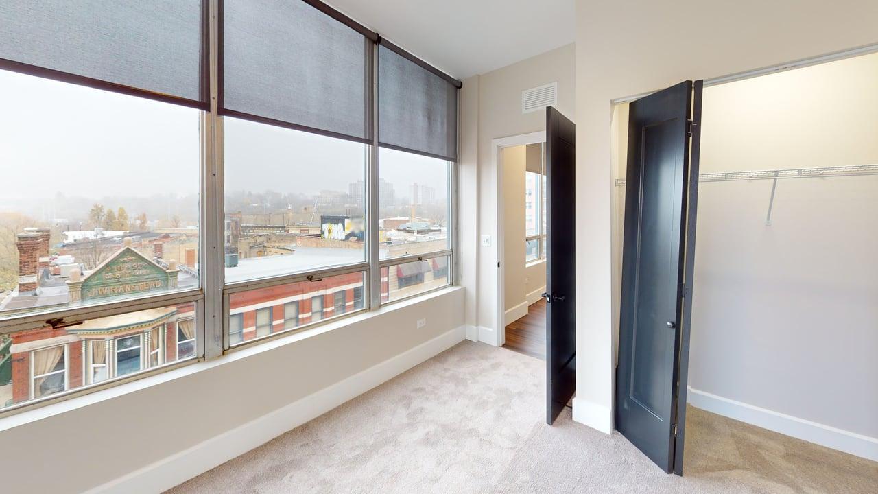 40 Dupage Court, Unit 409 Elgin, IL 60120 - Photo 17 of 22 a view of an empty room with a large window and kitchen view