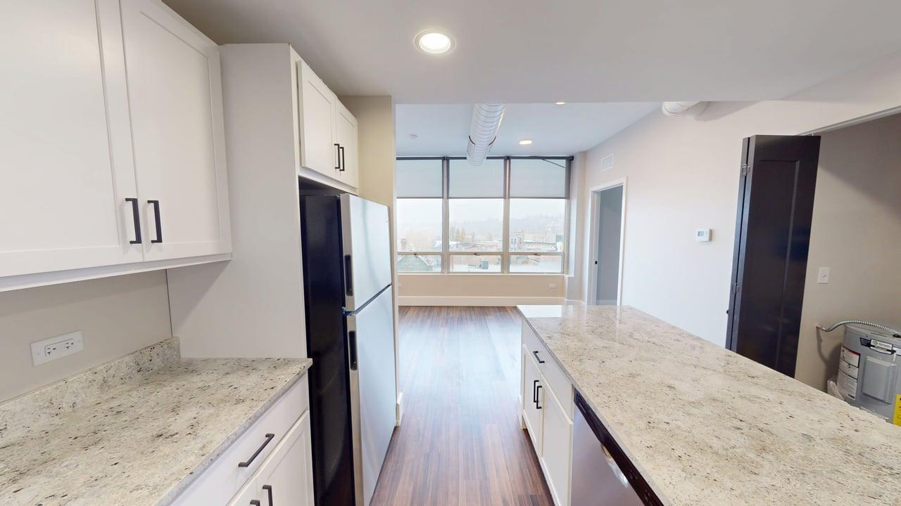 40 Dupage Court, Unit 409 Elgin, IL 60120 - Photo 9 of 22 a kitchen with granite countertop a refrigerator and a sink