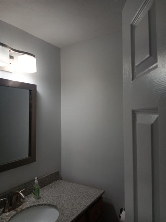 43 Merrymount Road, Unit 7 Quincy, MA 02169 - Photo 19 of 21 a bathroom with a granite countertop sink and a mirror