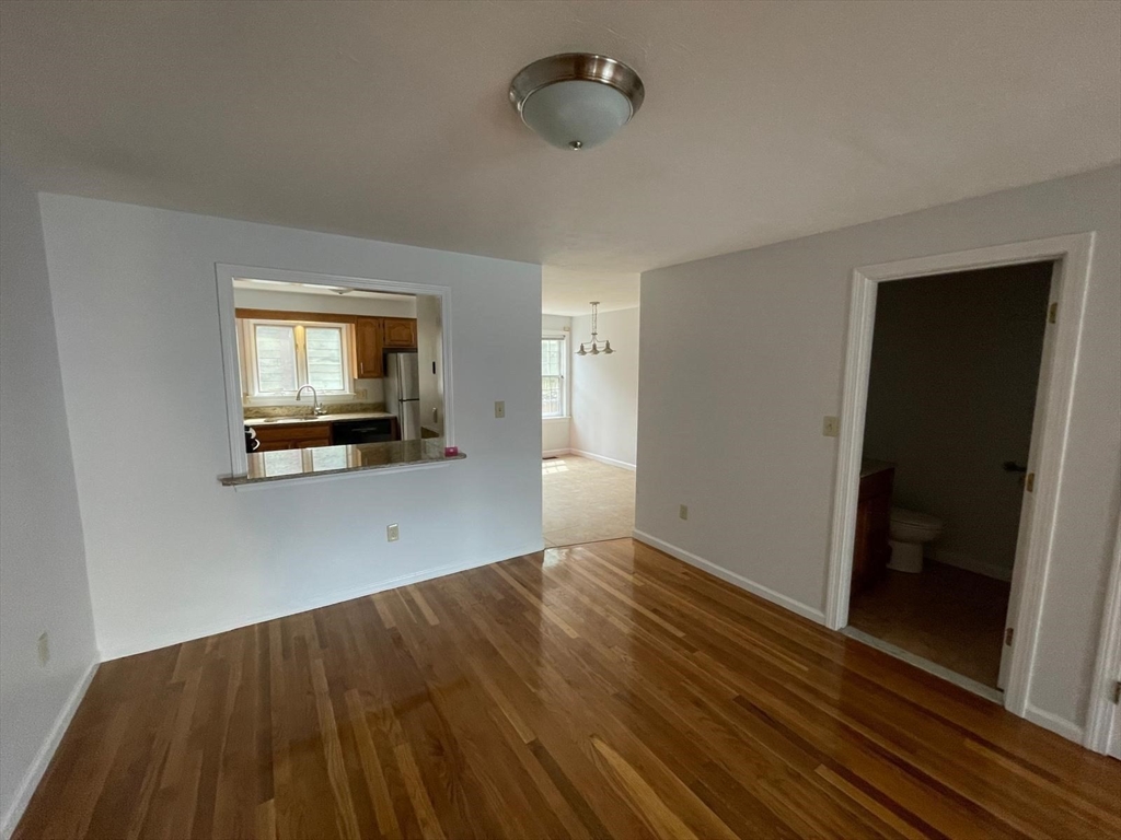 43 Merrymount Road, Unit 7 Quincy, MA 02169 - Photo 5 of 21 a view of an empty room with wooden floor and a window