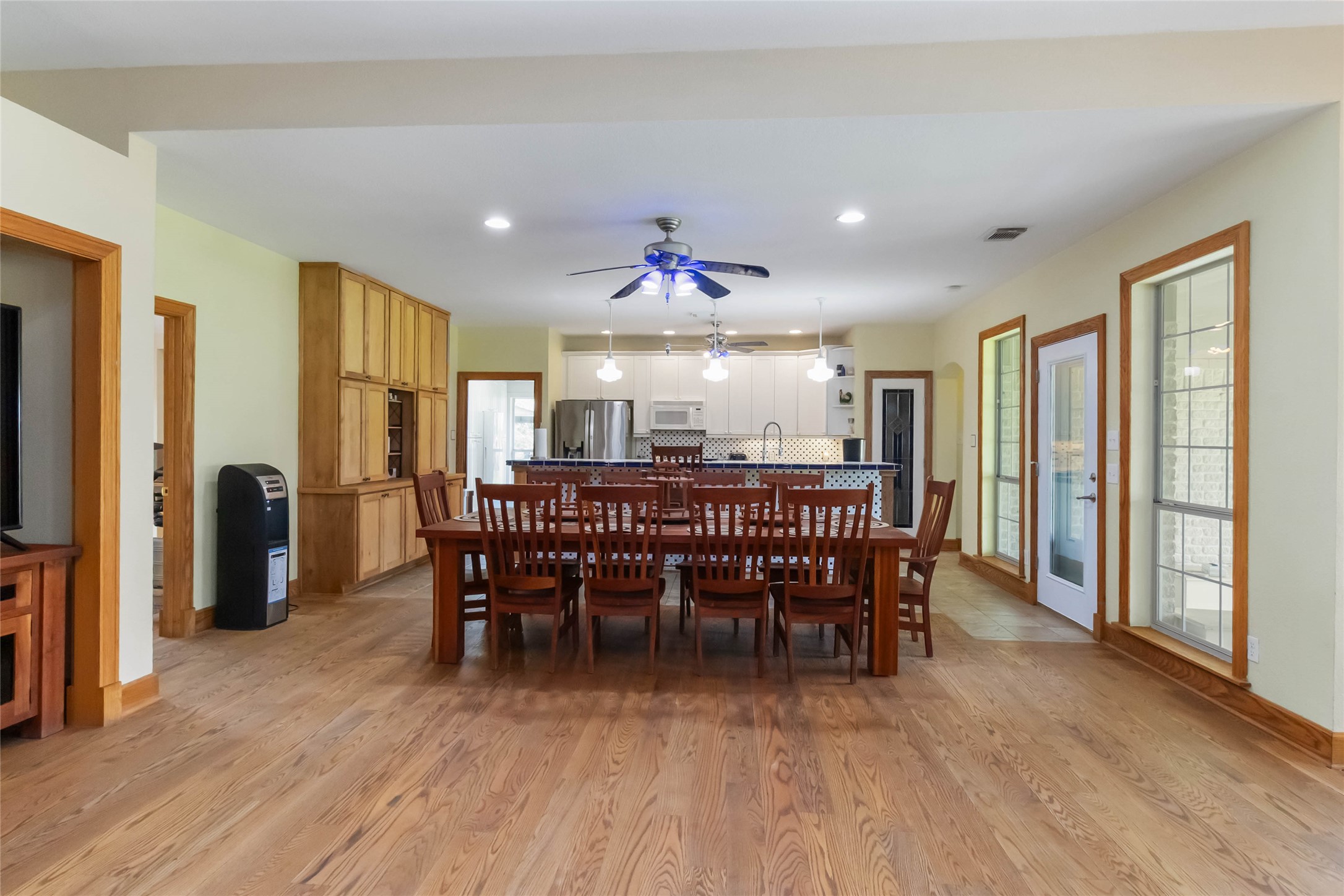 1208 Jeddo Road Rosanky, TX 78953 - Photo 10 of 40 Natural wood flooring extends throughout this generous dining area and into the well-equipped kitchen beyond.