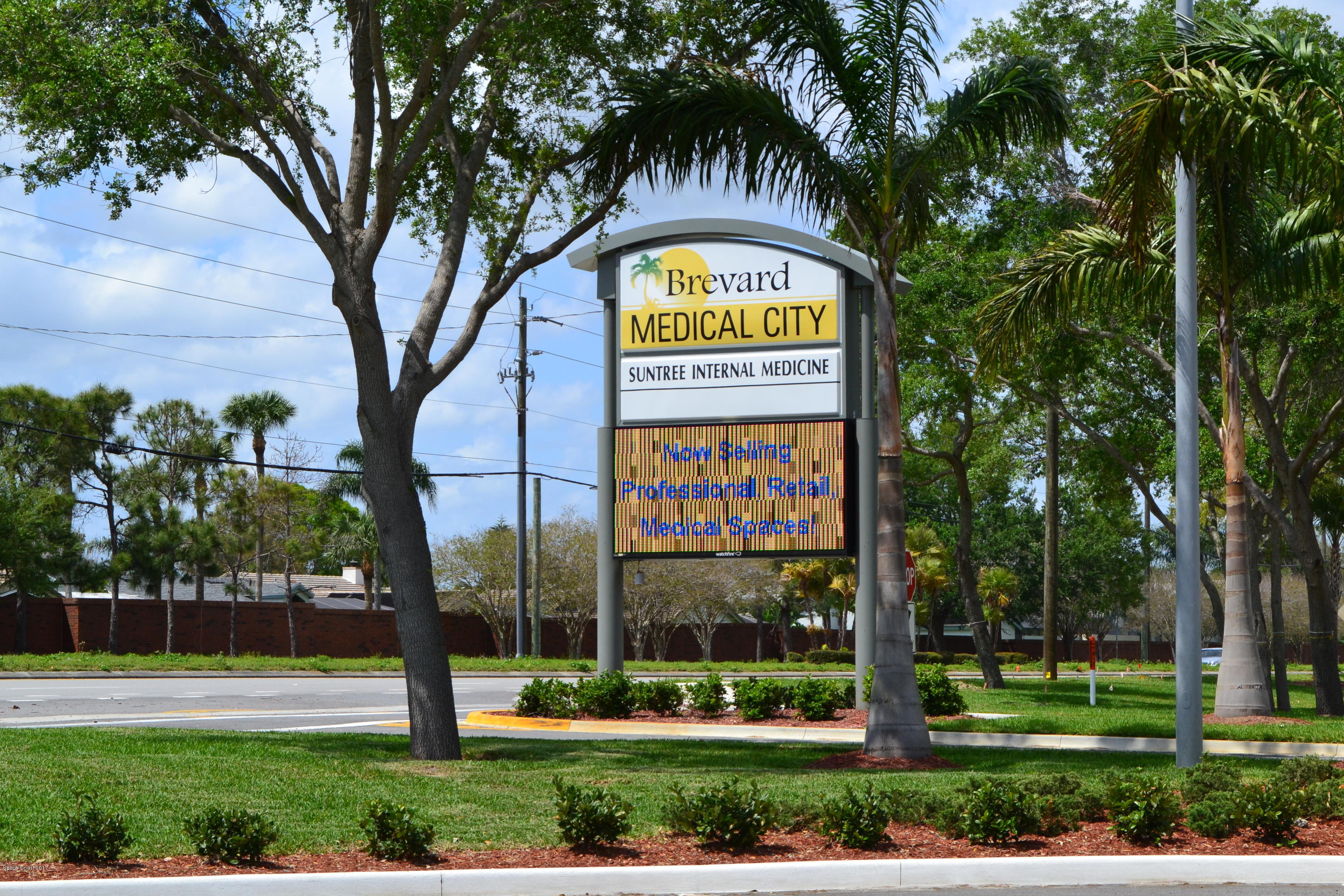 6555 North Wickham Road, Unit 106 Melbourne, FL 32940 - Photo 3 of 4 a sign that is sitting on the side of a road