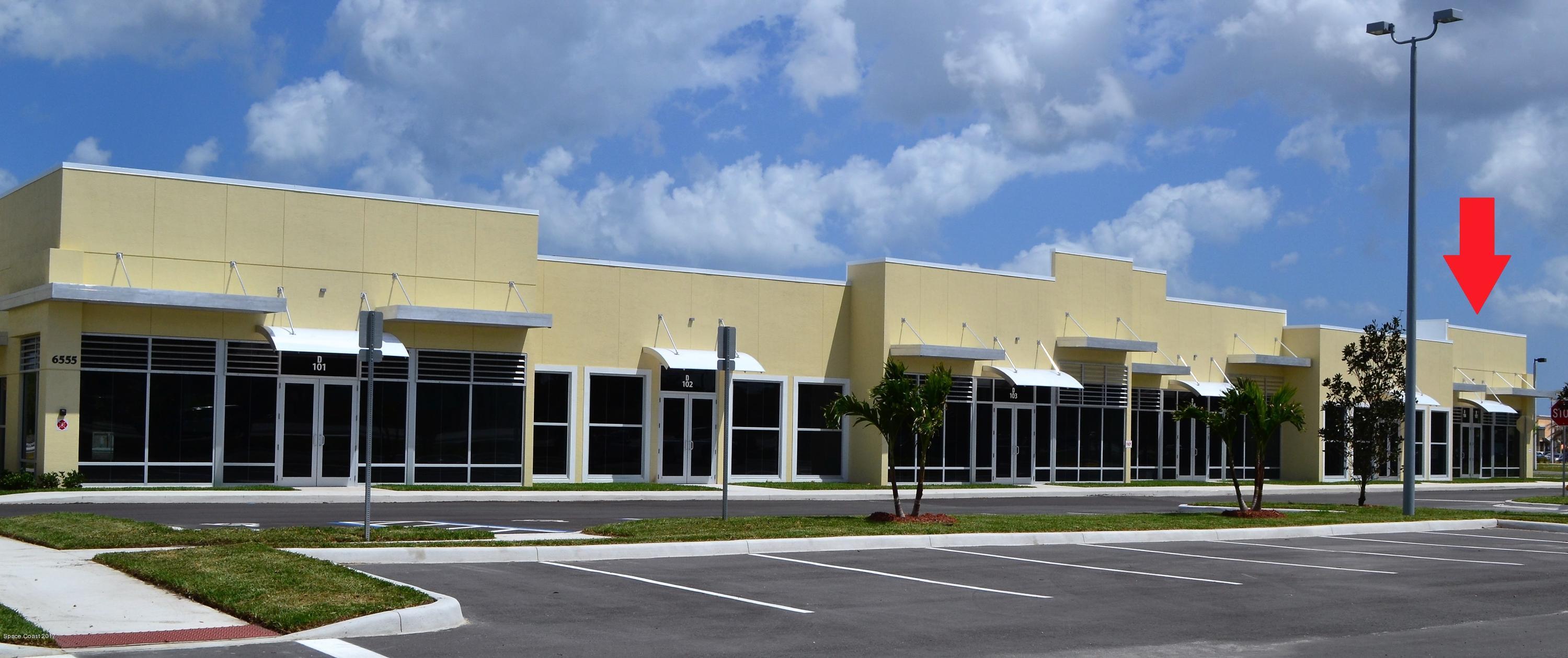 6555 North Wickham Road, Unit 106 Melbourne, FL 32940 - Photo 4 of 4 a view of a building with a street
