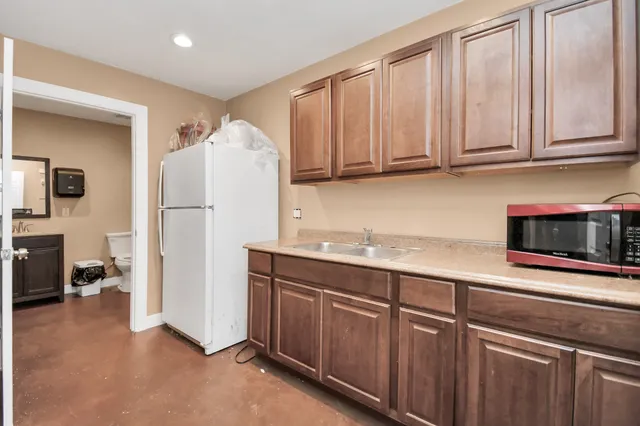 a kitchen with stainless steel appliances granite countertop a refrigerator sink and cabinets