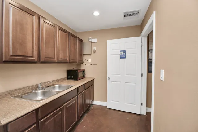 a kitchen with a sink and cabinets