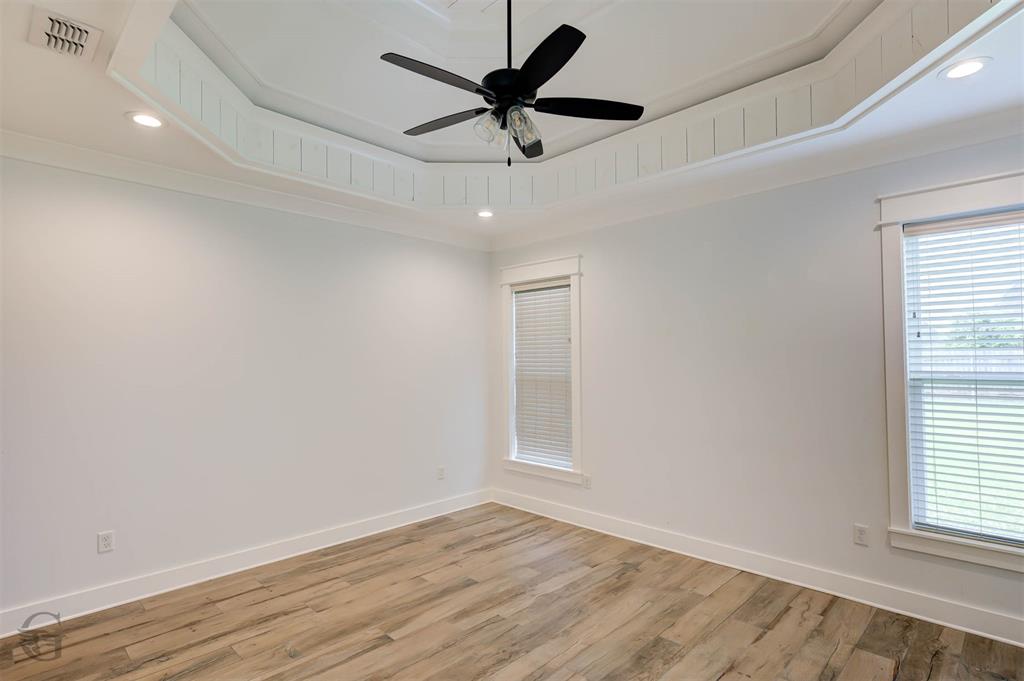 605 Meridian Way Benton, LA 71006 - Photo 22 of 29 Spacious interior room featuring a tray ceiling with recessed lighting and a ceiling fan, wood-finish flooring, and white trim