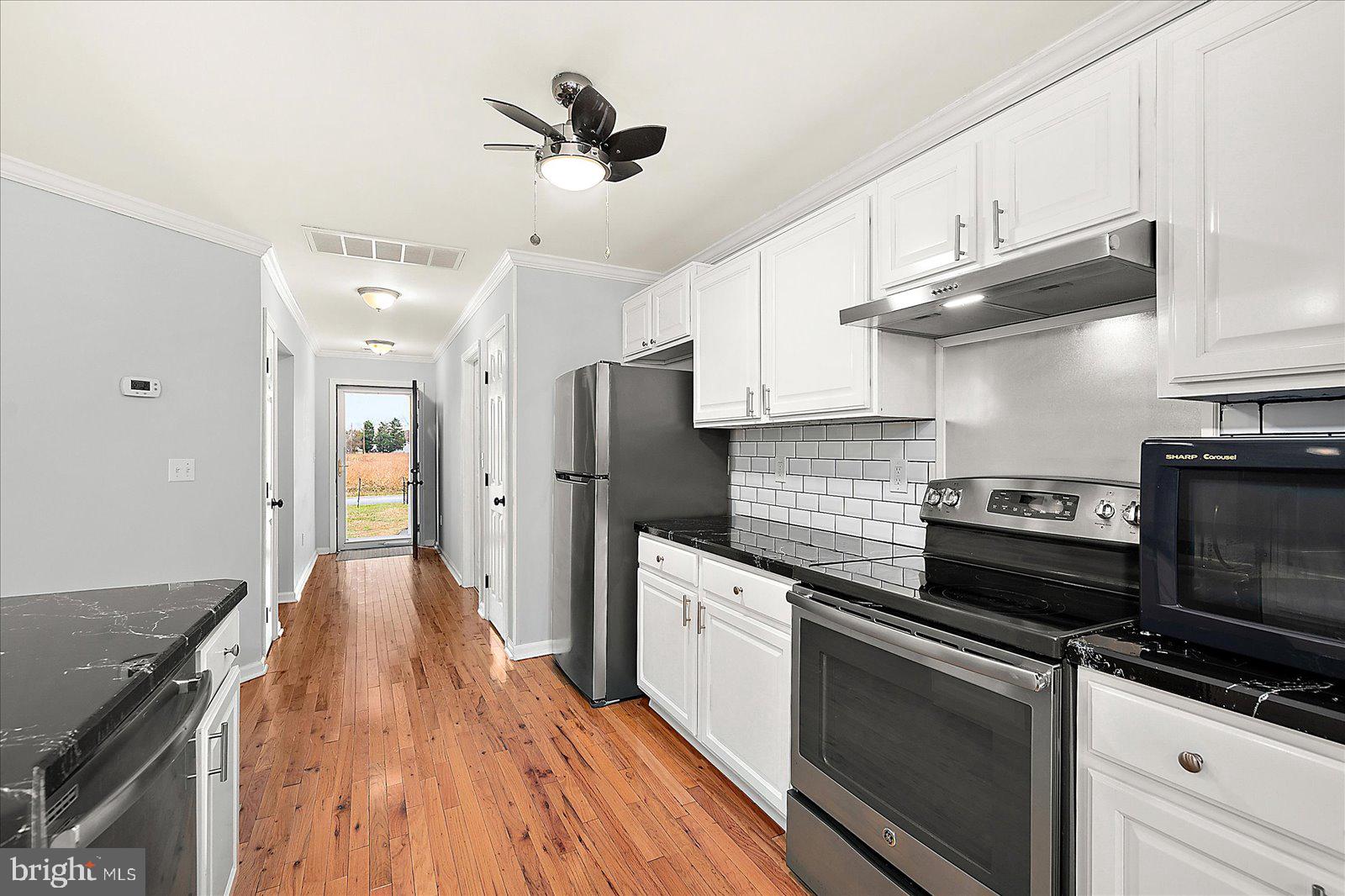 36405 Poplar Neck Road Willards, MD 21874 - Photo 20 of 50 a kitchen with stainless steel appliances a stove sink and refrigerator