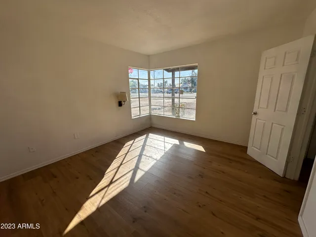 a view of an empty room and wooden floor